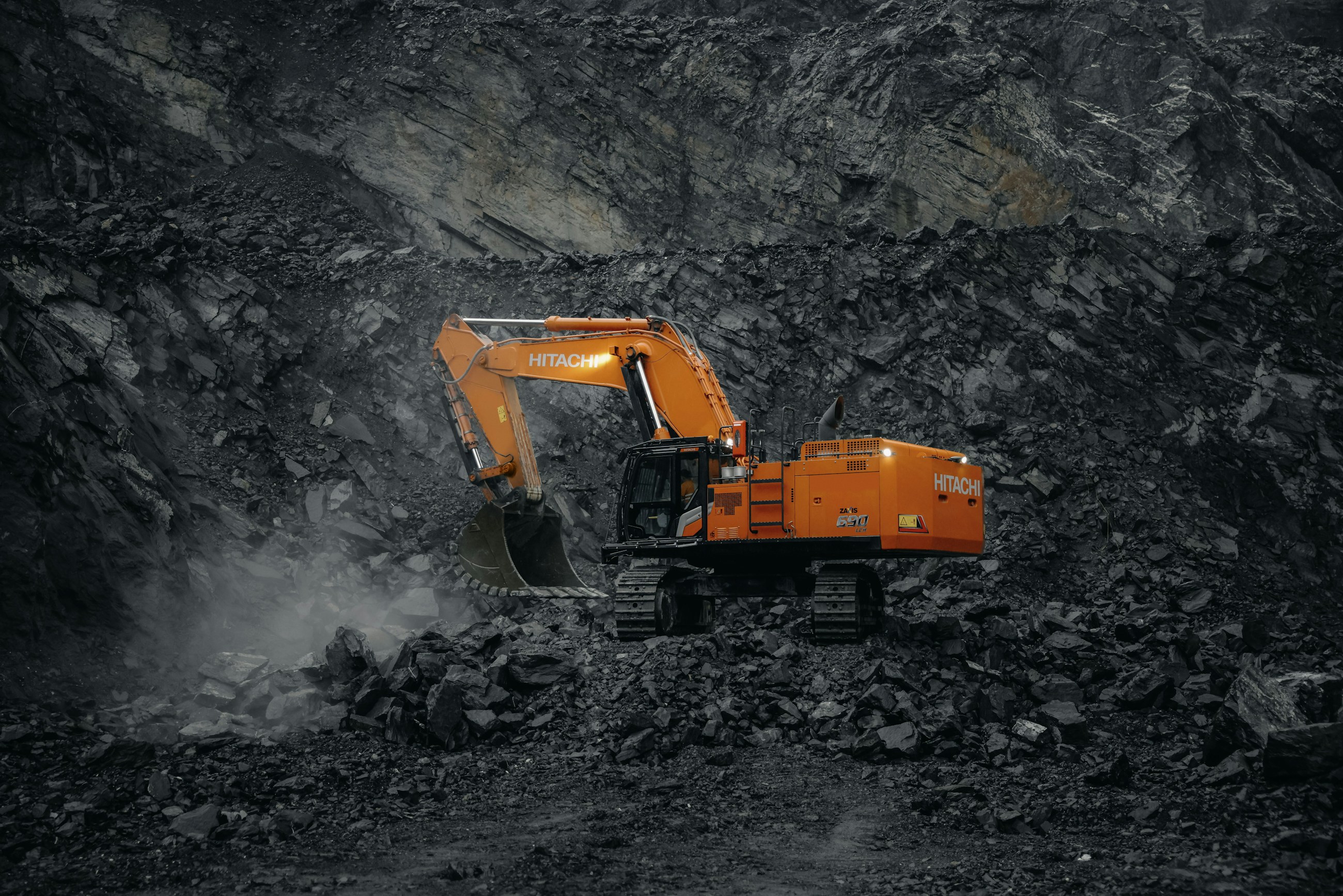 A working aggregate quarry seen from the air: pit face, crushing and screening plant, and stockpiles.